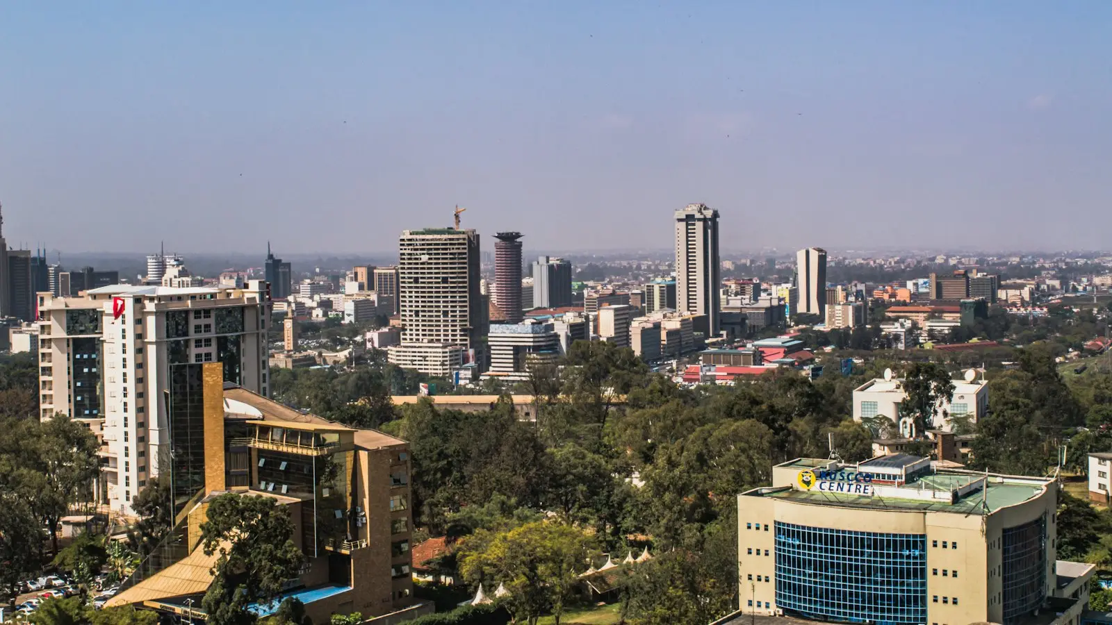 Nairobi's skyline seen across green trees on a clear morning